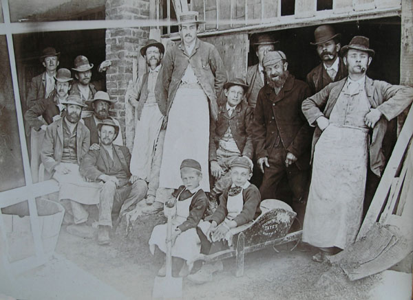 A photograph taken by Worthing stonemason Francis Tate depicting some of the men and boys employed at Tate’s Stoneworks (c1885).